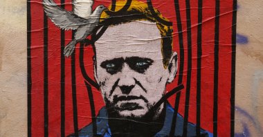 A view of a large poster depicting Russian opposition leader Alexei Navalny behind bars with a dove freeing him from detention, by an unidentified street artist known as Harry Greb, in downtown Rome, Italy, Jan. 25, 2021. (EPA Photo)