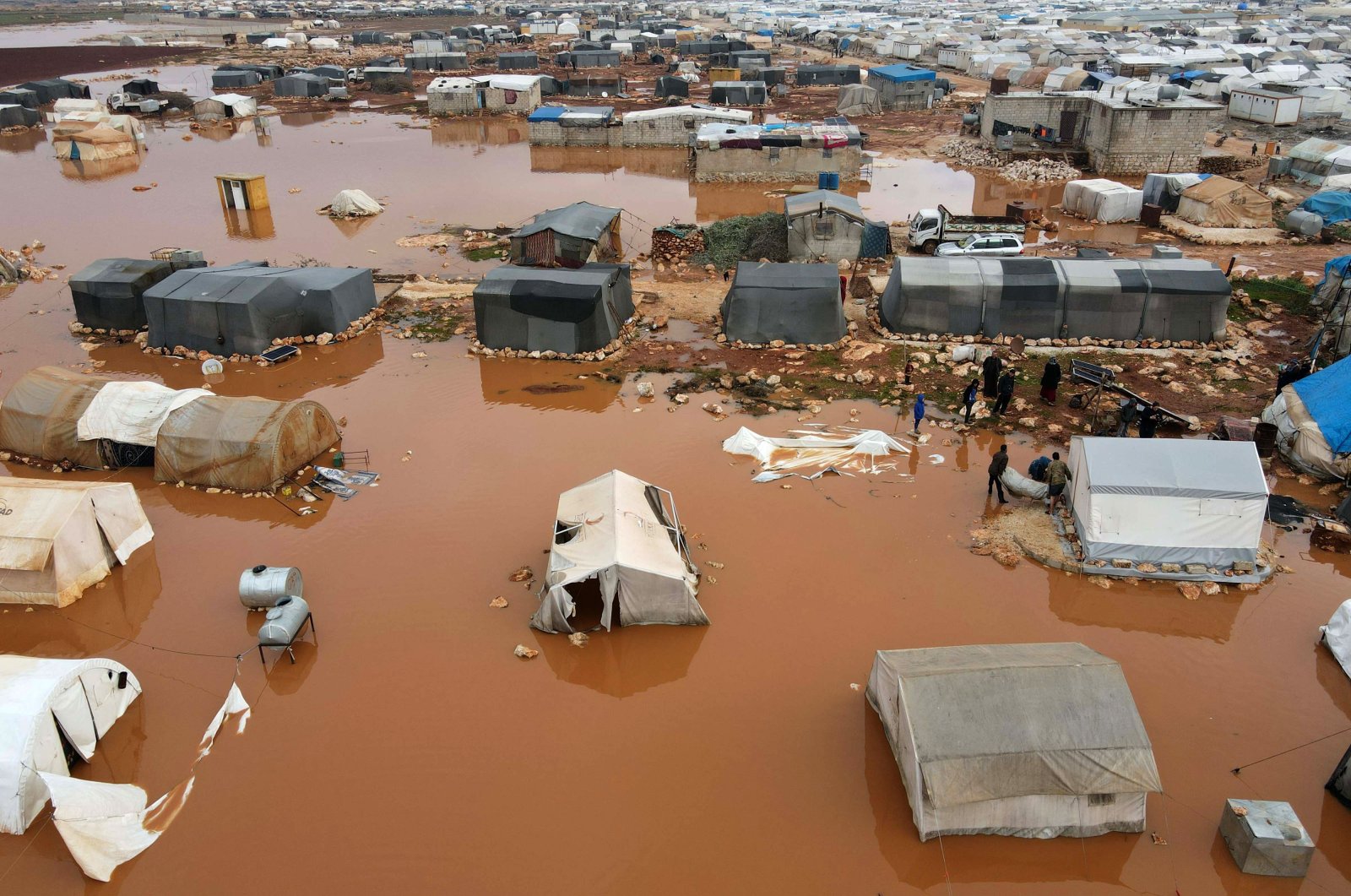 An aerial picture shows flooded tents after heavy rain at a camp for displaced Syrians near the town of Kafr Lusin by the border with Turkey, in northwestern province of Idlib, Syria, Jan. 19, 2021. (AFP Photo)