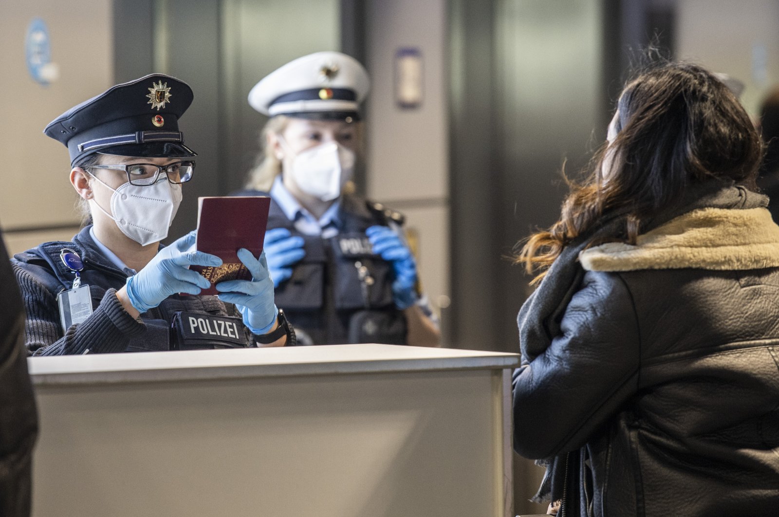 Officers of the German Federal Police check passengers arriving by plane from Prague at the Frankfurt Airport in Frankfurt, Germany on Jan. 24, 2021. (AP Photo)