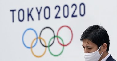 A man walks past a Tokyo Olympic Games advertising board outside the Tokyo Metropolitan Government Office in Tokyo, Japan, Jan. 27, 2021. (EPA Photo)
