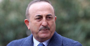 Turkey's Foreign Minister Mevlüt Çavuşoğlu addresses journalists ouside the Grand National Assembly in the capital Ankara, Jan. 25, 2021. (Photo by Adem ALTAN / AFP)