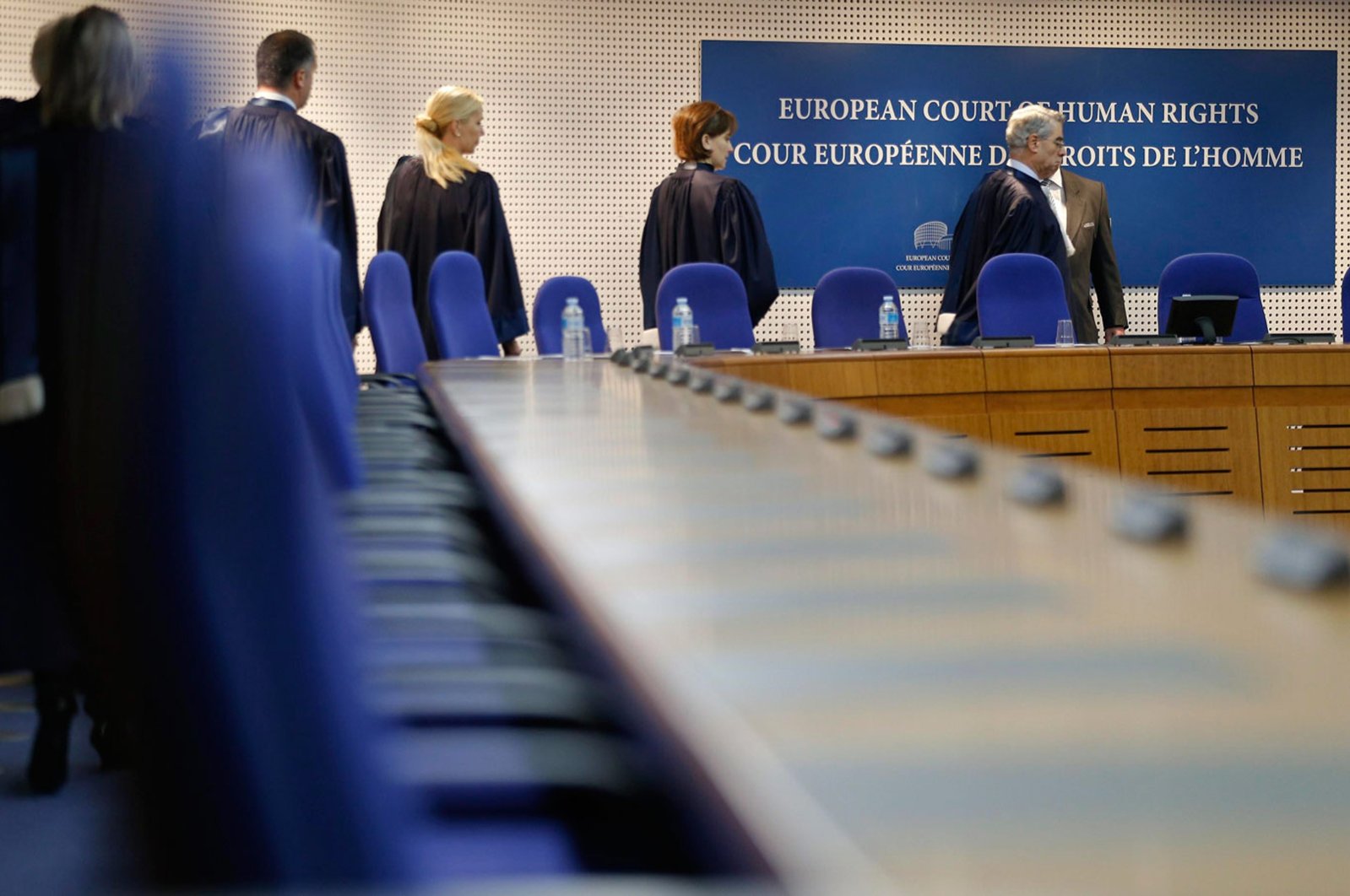 Judges of the European Court of Human Rights enter the hearing room of the court in Strasbourg, France, Dec. 3, 2013. 