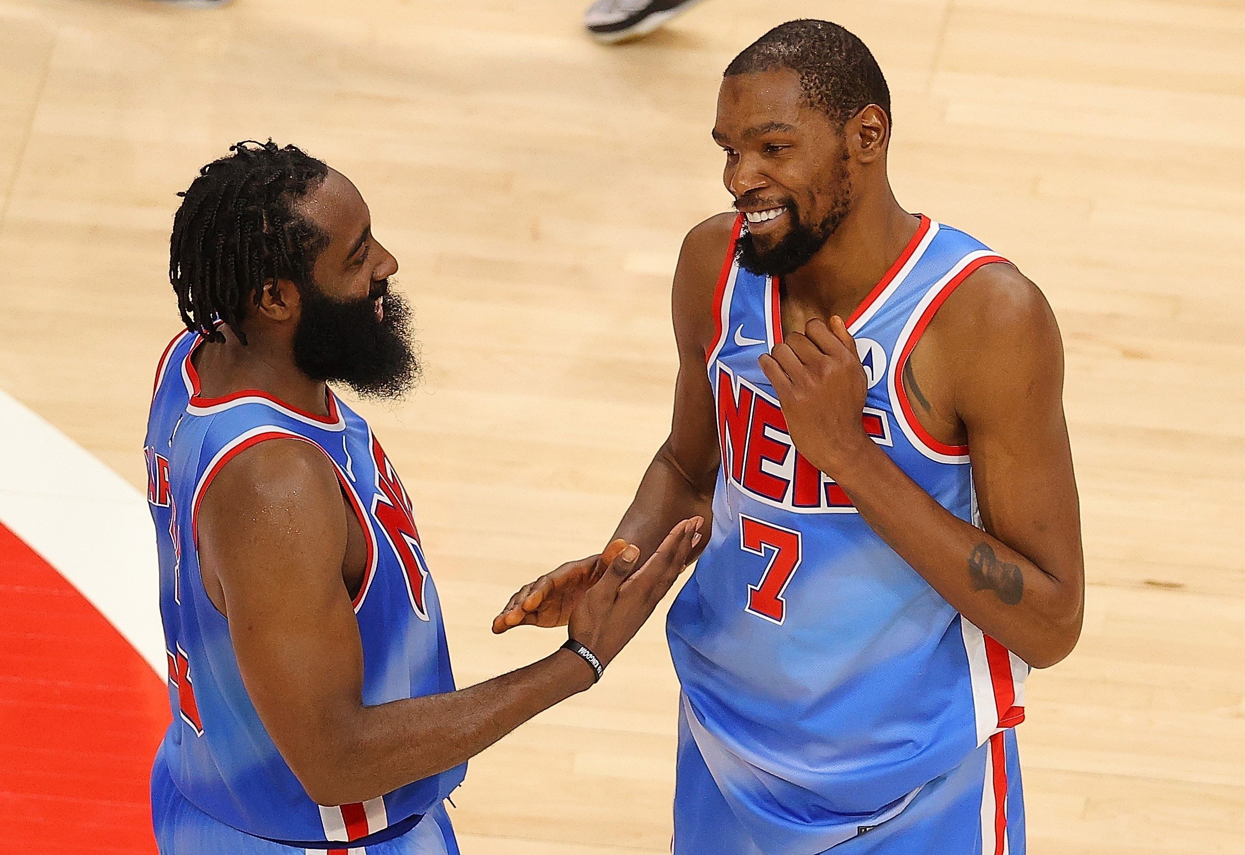 Brooklyn Nets' Kevin Durant (R) and James Harden (L) celebrate their 132-128 overtime win over the Atlanta Hawks at State Farm Arena, Atlanta, U.S., Jan. 27, 2021.