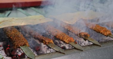 Traditional Adana kebab is grilled on iron skewers over an open mangal, a traditional Turkish barbecue, in Adana, southern Turkey, Jan. 14, 2021. (IHA Photo)