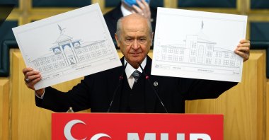 Nationalist Movement Party (MHP) Chairperson Devlet Bahçeli during his party's parliamentary group meeting in Ankara shows the plans of the school to be built in Azerbaijan's key city Shusha, Jan. 26, 2021. (AA Photo)
