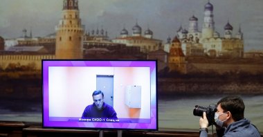 A photographer takes pictures of a screen showing Russian opposition leader Alexei Navalny via a video link during a court hearing to consider an appeal on his arrest outside Moscow, Russia, Jan. 28, 2021. (Reuters Photo)
