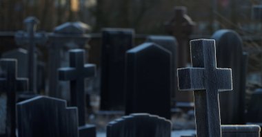 Sunlight hits frost-covered headstones in a graveyard in Manchester, Britain, Jan. 25, 2021. (Reuters Photo)
