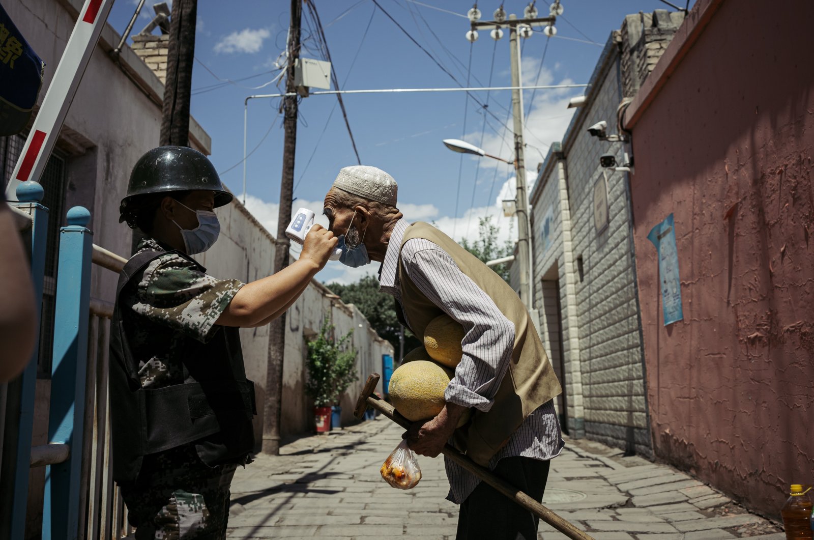 An elderly Uighur man is tested at a temperature checkpoint, Kuqa, Xinjiang Uighur Autonomous Region, China, June 29, 2020. (Photo by Getty Images)