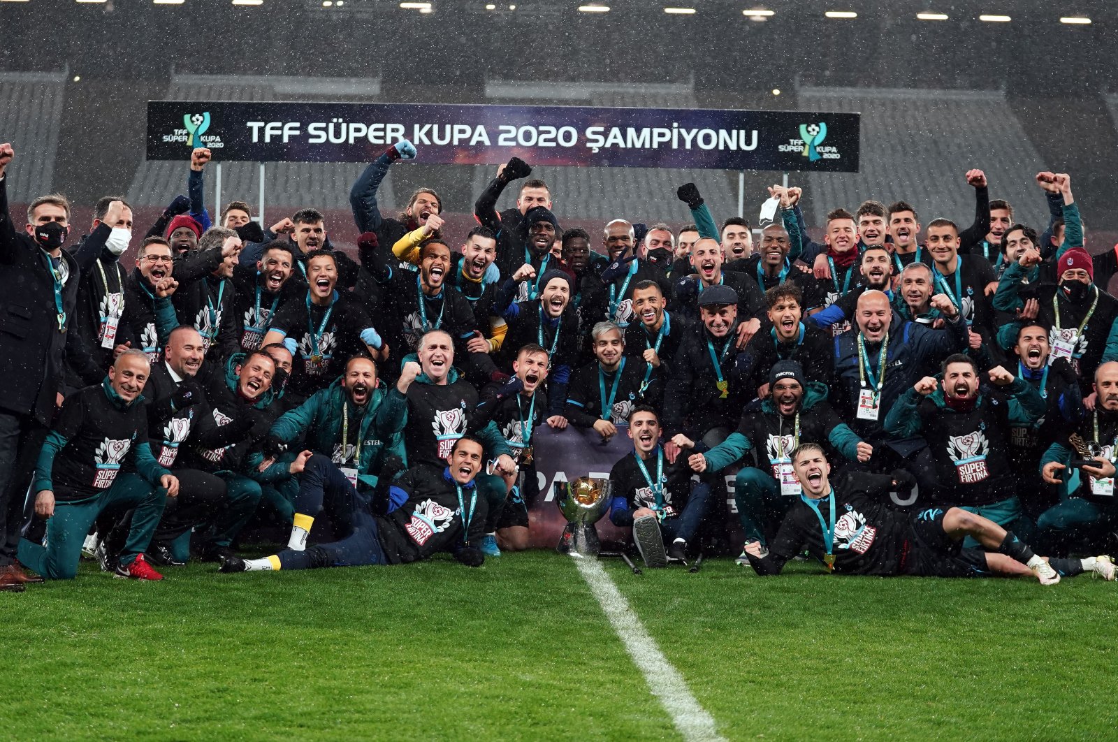 Trabzonspor players and staff pose with the Turkish Super Cup trophy, Atatürk Olympic Stadium, Istanbul, Turkey, Jan. 27, 2021. 