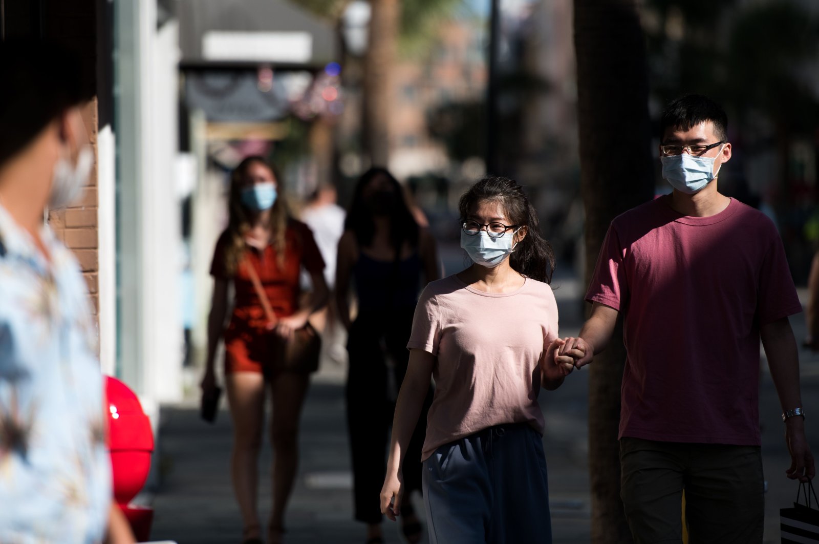 People wearing protective masks walk along King Street in Charleston, South Carolina, the U.S., July 17, 2020. (AFP Photo)