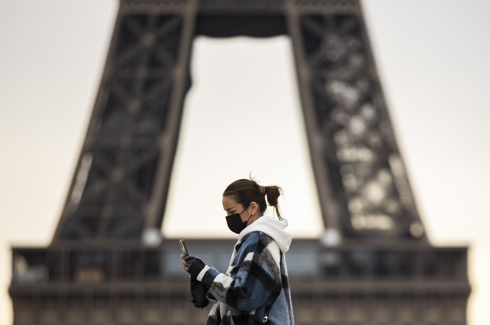 A pedestrian wearing a protective mask walks near the Eiffel Tower in Paris, France, Jan. 26, 2021. (EPA Photo)