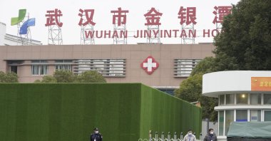 Security personnel guard an entrance to the Wuhan Jinyintan Hospital which a team from the World Health Organization visited in Wuhan in central China's Hubei province on Saturday, Jan. 30, 2021. (AP Photo/)