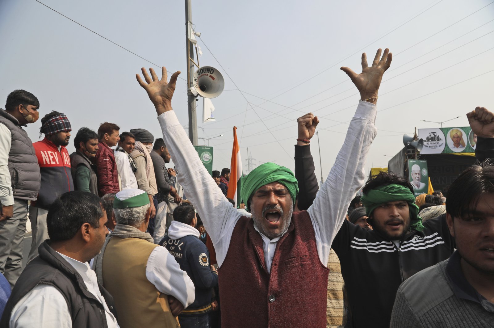 Farmers shout slogans as they arrive at the site of ongoing protests against farm laws at the Delhi-Uttar Pradesh border, on the outskirts of New Delhi, India, Friday, Jan. 29, 2021. (AP Photo)