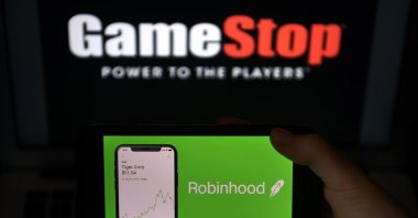 This photo illustration shows the logos of the video game retail store GameStop and the trading application Robinhood, Arlington, Virginia, the U.S., Jan. 28, 2021. (AFP Photo)