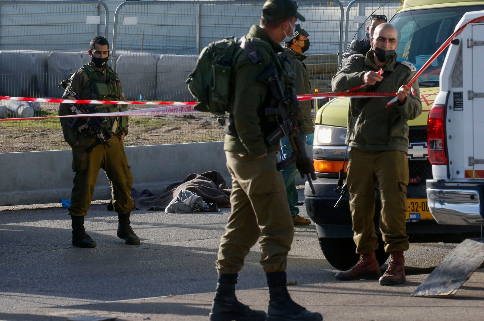 The body of a Palestinian man shot by Israeli security forces lays by the side of the road near Gosh Etzion, north of Hebron city in the occupied West Bank, Jan. 31, 2021. (AFP Photo)