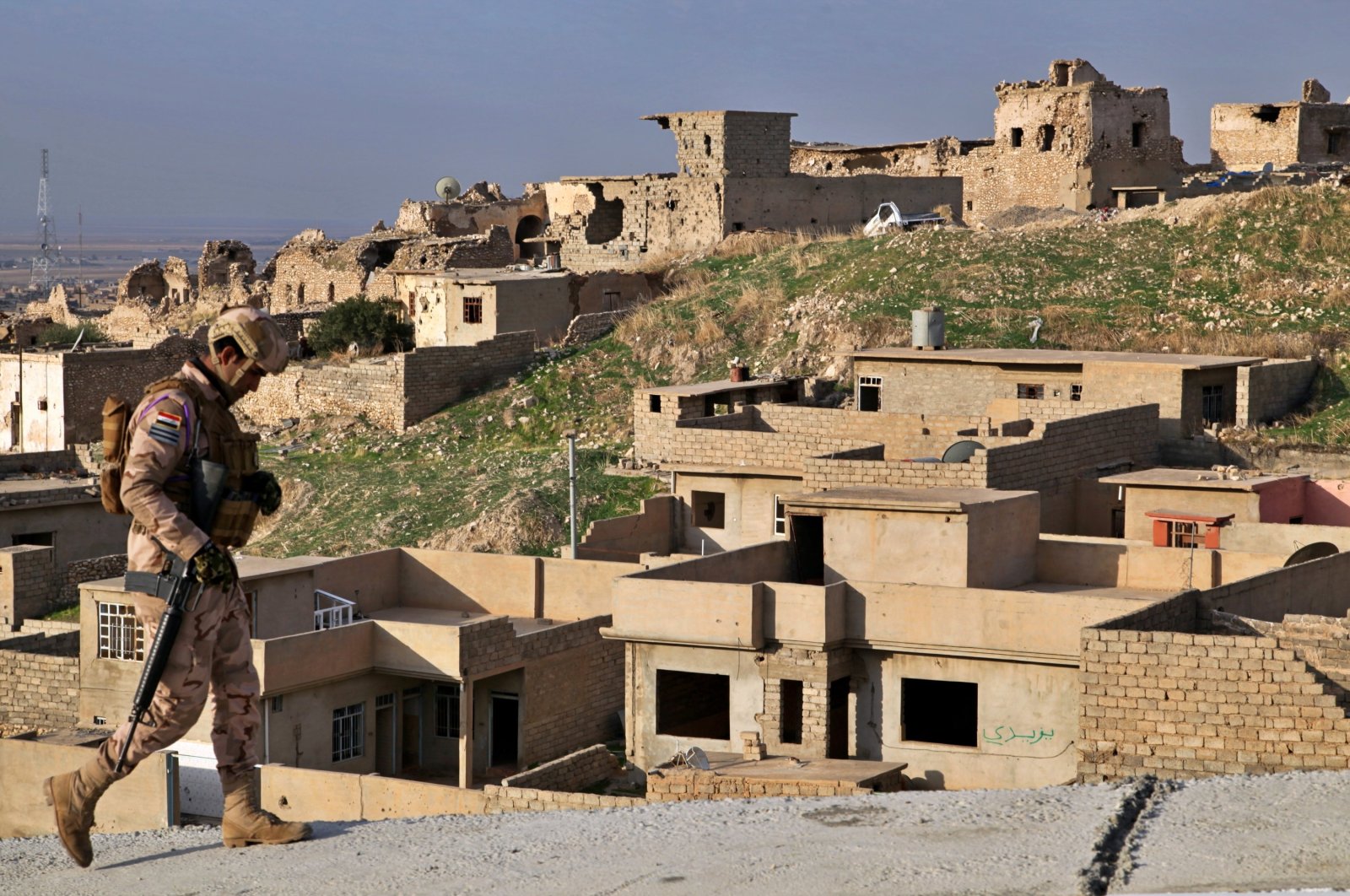 An Iraqi army soldier walks by ruins still deserted three years since the defeat of the Daesh terrorist group in Sinjar, Iraq, Dec. 4, 2020. (AP File Photo)