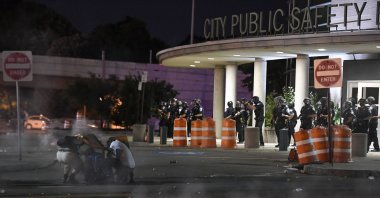 Demonstrators take cover from chemical irritants released by police in front of the Public Safety Building in Rochester, New York, U.S., Sept. 3, 2020. (AP Photo)