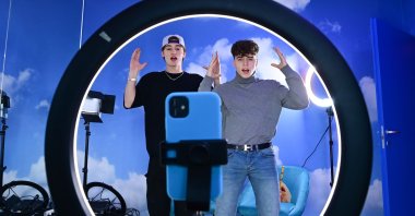 (L-R) TikTok influencers Marco Bonetti and Davide Moccia perform a video in the "Defhouse", a TikTok influencers incubator in Milan, on January 21, 2021. (AFP Photo)