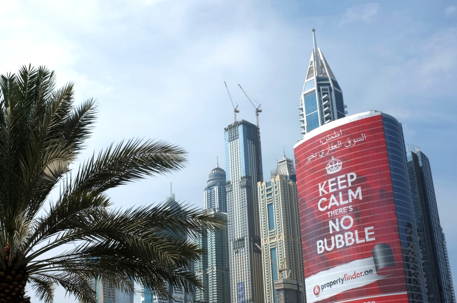 An advertising sign for a real estate company reading "Keep Calm There's no Bubble" is seen on a building in the Marina district of Dubai, United Arab Emirates, Nov. 19, 2013. (Reuters Photo)