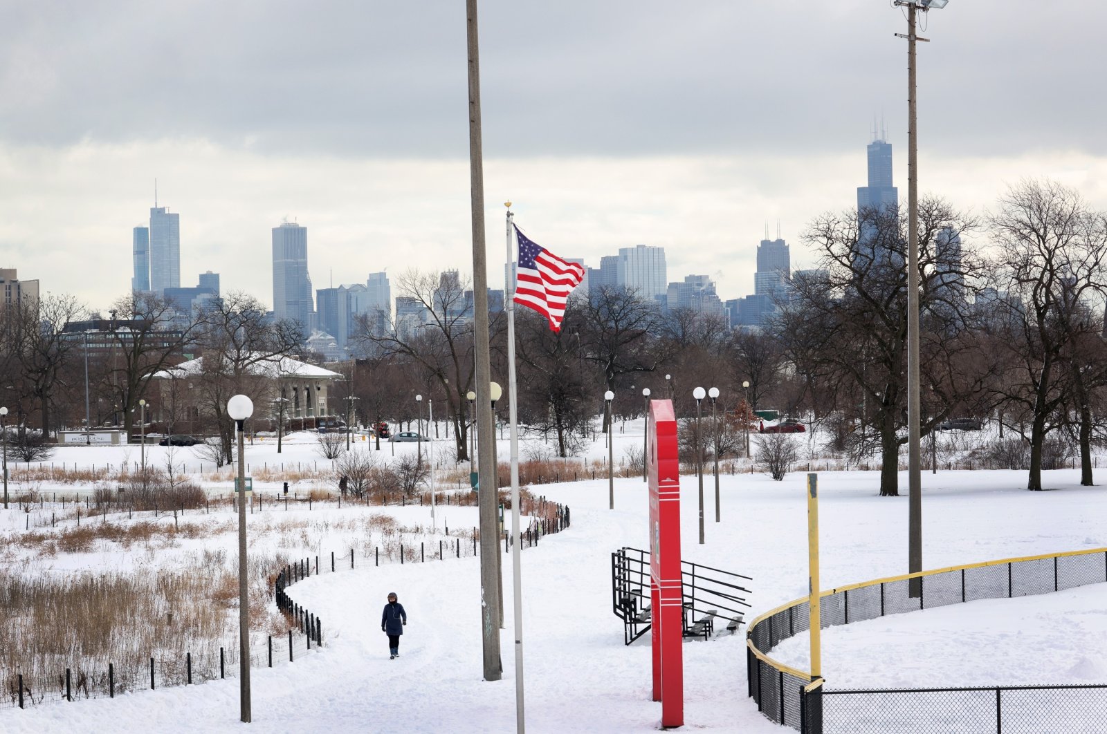 A woman walks down a snow-covered path in Humboldt Park in Chicago, Illinois, U.S., Feb. 1, 2021. (AFP Photo)