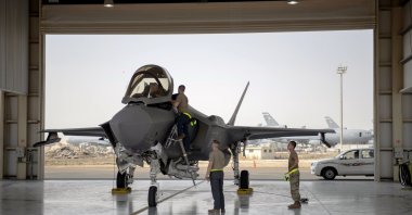 An F-35 fighter jet pilot and crew prepare for a mission at Al-Dhafra Air Base, in the United Arab Emirates, Aug. 5, 2019. (U.S. Air Force via AP)