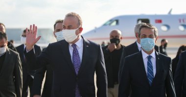 Foreign Minister Mevlüt Çavuşoğlu is welcomed by his Turkish Cypriot counterpart Tahsin Ertuğruloğlu after landing in Ercan Airport in Lefkoşa (Nicosia), Feb.1, 2021. (AA)