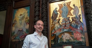 Venizelos Gavrilakis, a senior restorer and conservator from Thessaloniki, Greece, poses with a 16th century Byzantine Christian icon after completing its restoration at a Greek Orthodox church where he set up his laboratory in Istanbul, Turkey, Jan. 26, 2021. (Reuters photo)