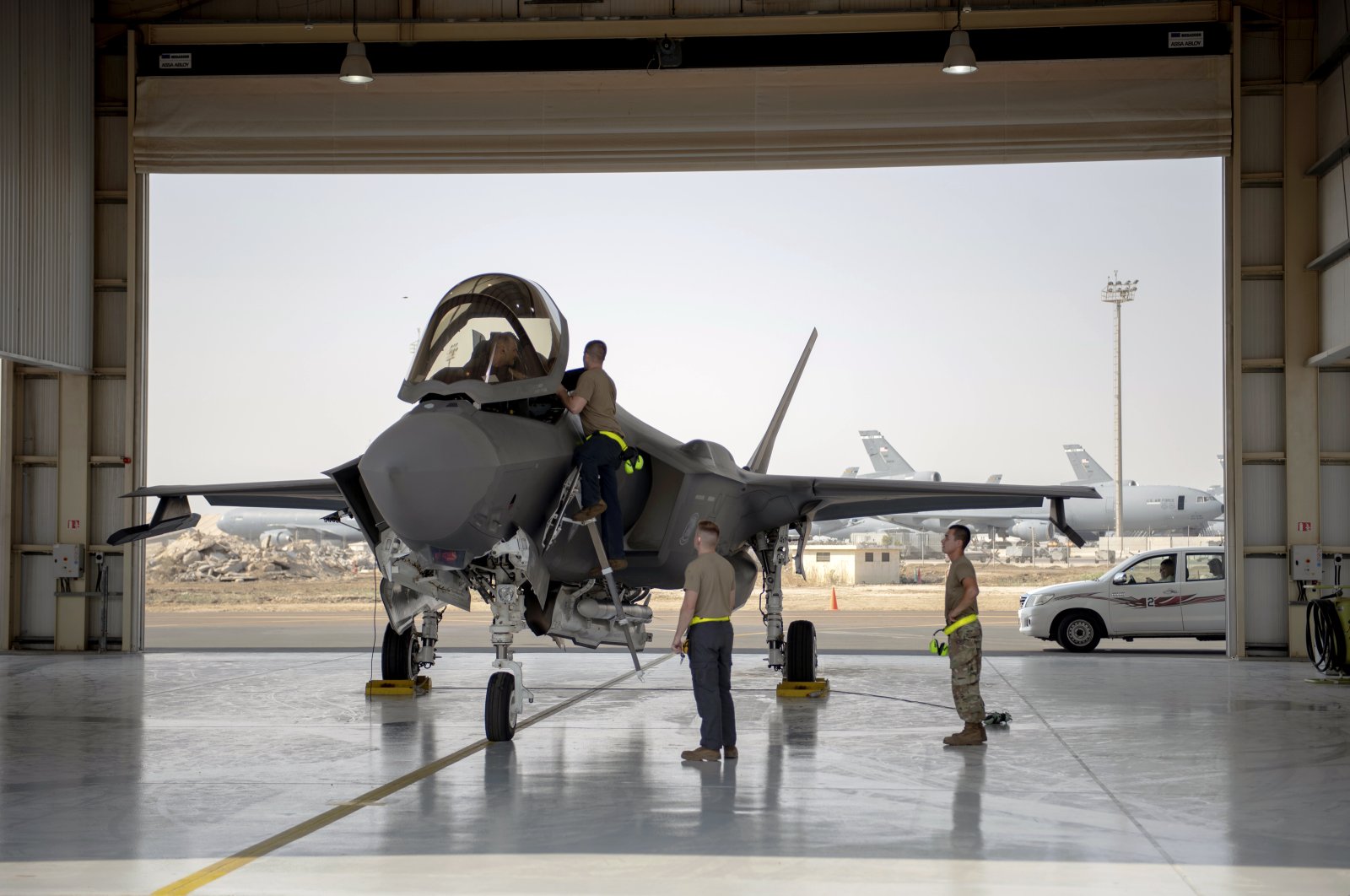 An F-35 fighter jet pilot and crew prepare for a mission at Al-Dhafra Air Base, in the United Arab Emirates, Aug. 5, 2019. (U.S. Air Force via AP)