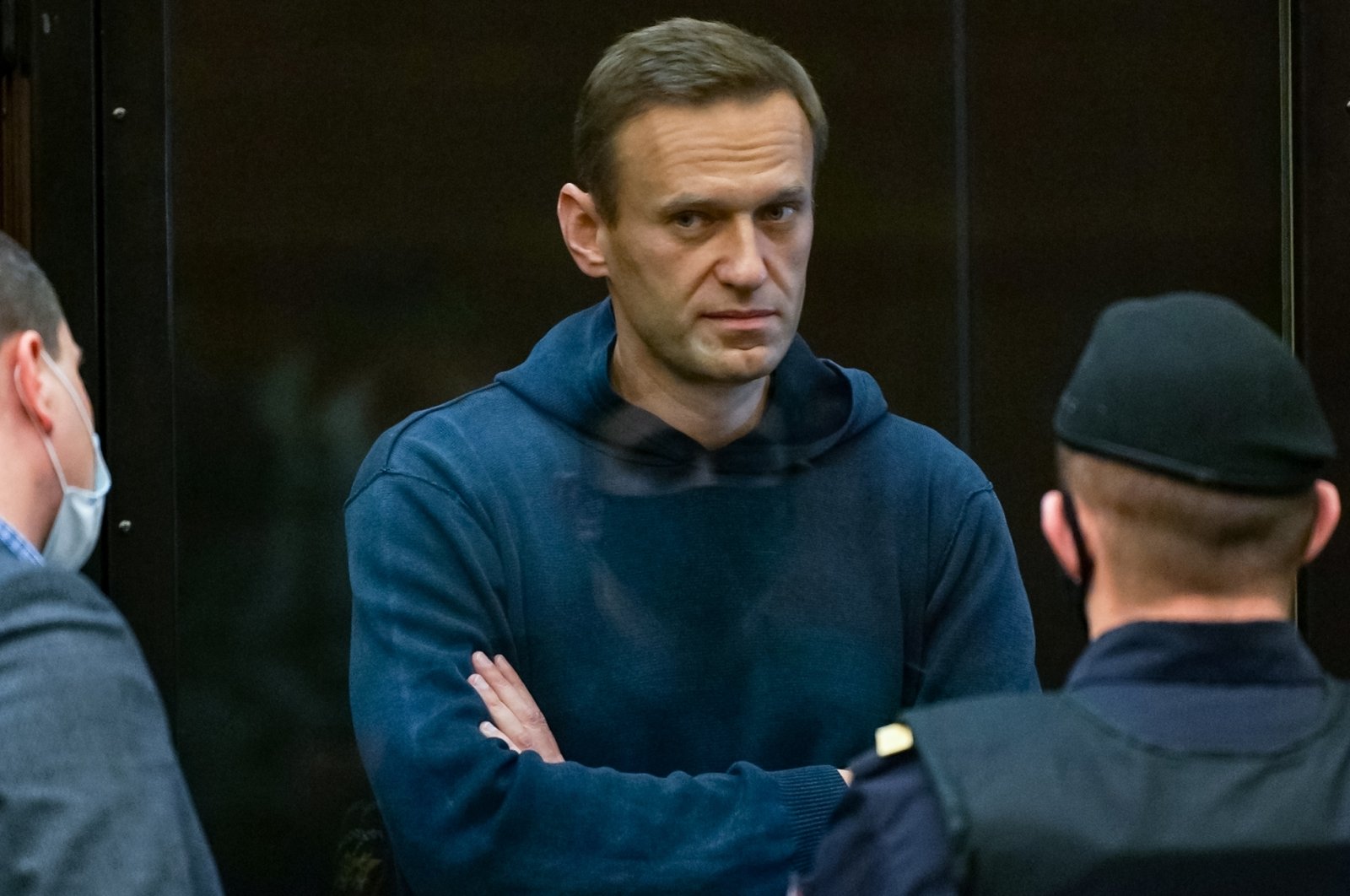 Russian opposition figure Alexei Navalny stands inside a glass cell during a court hearing in Moscow, Russia on Feb. 2, 2021. (Moscow City Court Press Service via AFP)