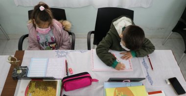 Two children take part in online lessons in a neighborhood building where they are able to access the internet in Bayramlı village, Uzunköprü district, Edirne province, northwestern Turkey, Jan. 13, 2021. (AA Photo)