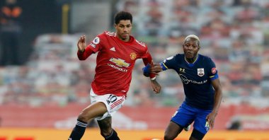 Manchester United's Marcus Rashford (L) goes past Southampton's Moussa Djenepo during their Premier League match, Old Trafford, Manchester, Feb. 2, 2021.
