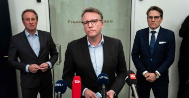 Denmark's Minister of Taxation Morten Boedskov (C), CEO of the Danish Chamber of Commerce Brian Mikkelsen (R) and DI Director Lars Sandahl Soerensen (L) hold a news conference on a digital coronavirus passport that the Danish government is developing for people already vaccinated against COVID-19, at the Ministry of Finance in Copenhagen, Denmark, Feb. 3, 2021. (AFP Photo)