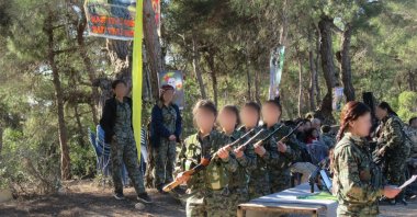 Children forcibly recruited by PKK/YPG terrorists are seen during training at an unknown location, Aug. 3, 2018. (AA)