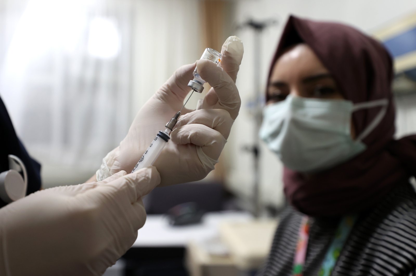 A health care worker waits to be vaccinated with the CoronaVac at the Bursa Yüksek Ihtisas Training and Research Hospital in Bursa, northwestern Turkey, Jan. 14, 2021. (AA Photo)