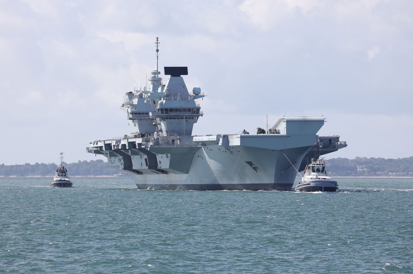 The aircraft carrier HMS Queen Elizabeth returns to its home port after the completion of Exercise Crimson Ocean, Portsmouth, Britain, July 2, 2020. (Shutterstock Photo)
