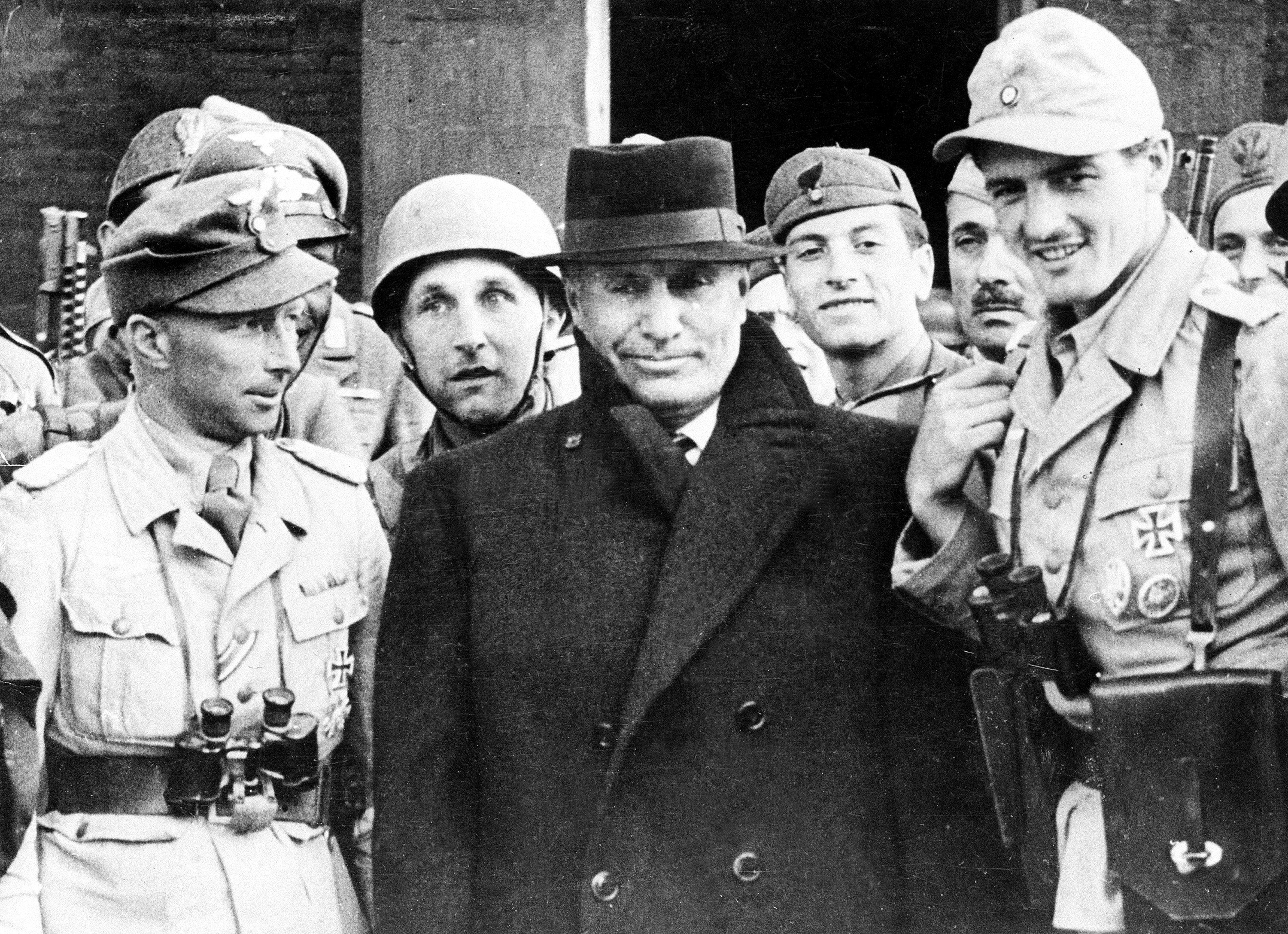 During World War II, Benito Mussolini (C), surrounded by German paratroopers who rescued him from imprisonment, is in front of a hotel in the Gran Sasso Mountain area, Italy, September 1943. (AP Photo)