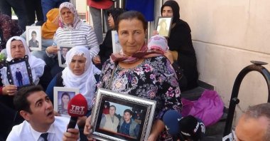 Selma Han holds a photo of herself and her son Onor Han, who was kidnapped by PKK terrorists, during a protest in front of the Peoples’ Democratic Party's (HDP) headquarters in Turkey's southeastern Diyarbakır province, Feb. 4, 2021. (DHA Photo)