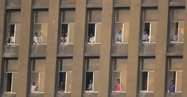 Bangladeshis watch from a building the 2018 FIFA World Cup qualifying soccer match between Jordan and Bangladesh in Dhaka, Bangladesh, Sept. 8, 2015. (AP Photo)