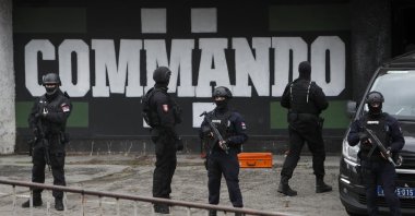 Serbian police officers guard Partizan stadium during a raid, in Belgrade, Serbia, Feb. 4, 2021. (AP Photo)