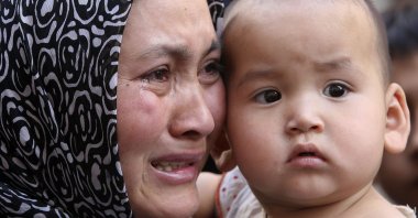 A Uighur woman cries as reporters visit a Uighur district that protested in Urumqi, Xinjiang Uighur Autonomous Region, western China, July 9, 2009. (AP Photo/Eugene Hoshiko)