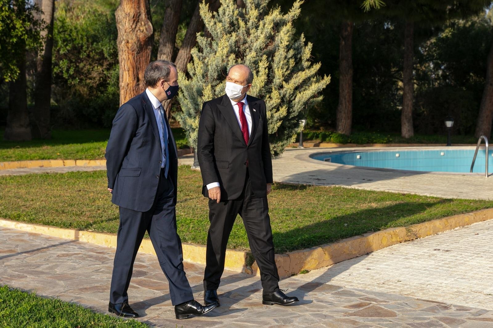 Turkish Republic of Northern Cyprus (TRNC) President Ersin Tatar walks with British Foreign Secretary Dominic Raab in Lefkoşa, TRNC on Feb. 4, 2021. (AA Photo)