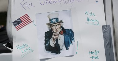 A sign is seen on a vehicle in a caravan protest against unemployment, Miami Beach, Florida, U.S., May 22, 2020. (Photo by Getty Images)