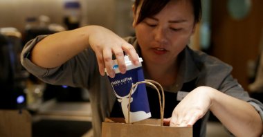 A barista packs a coffee at a Luckin Coffee shop in Beijing, China, July 17, 2018. (Reuters Photo)