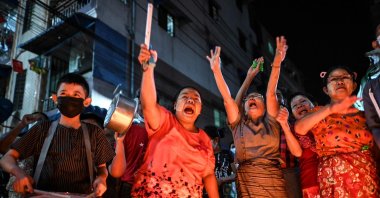 People take part in a noise campaign on the street after calls for protest against the military coup emerged on social media, in Yangon, Myanmar, Feb. 5, 2021. (AFP Photo)