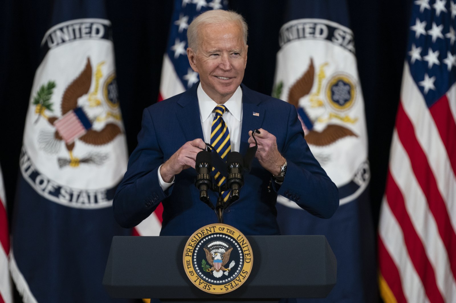 U.S. President Joe Biden smiles as he arrives to deliver remarks to State Department staff, Washington, D.C., U.S., Feb. 4, 2021. (AP Photo)