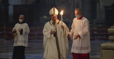 Pope Francis holds a candle as he arrives to celebrate a mass with members of religious institutions on the occasion of the celebration of the World Day of Consecrated Life, in St. Peter's Basilica at the Vatican, Feb. 2, 2021. (AP Photo)