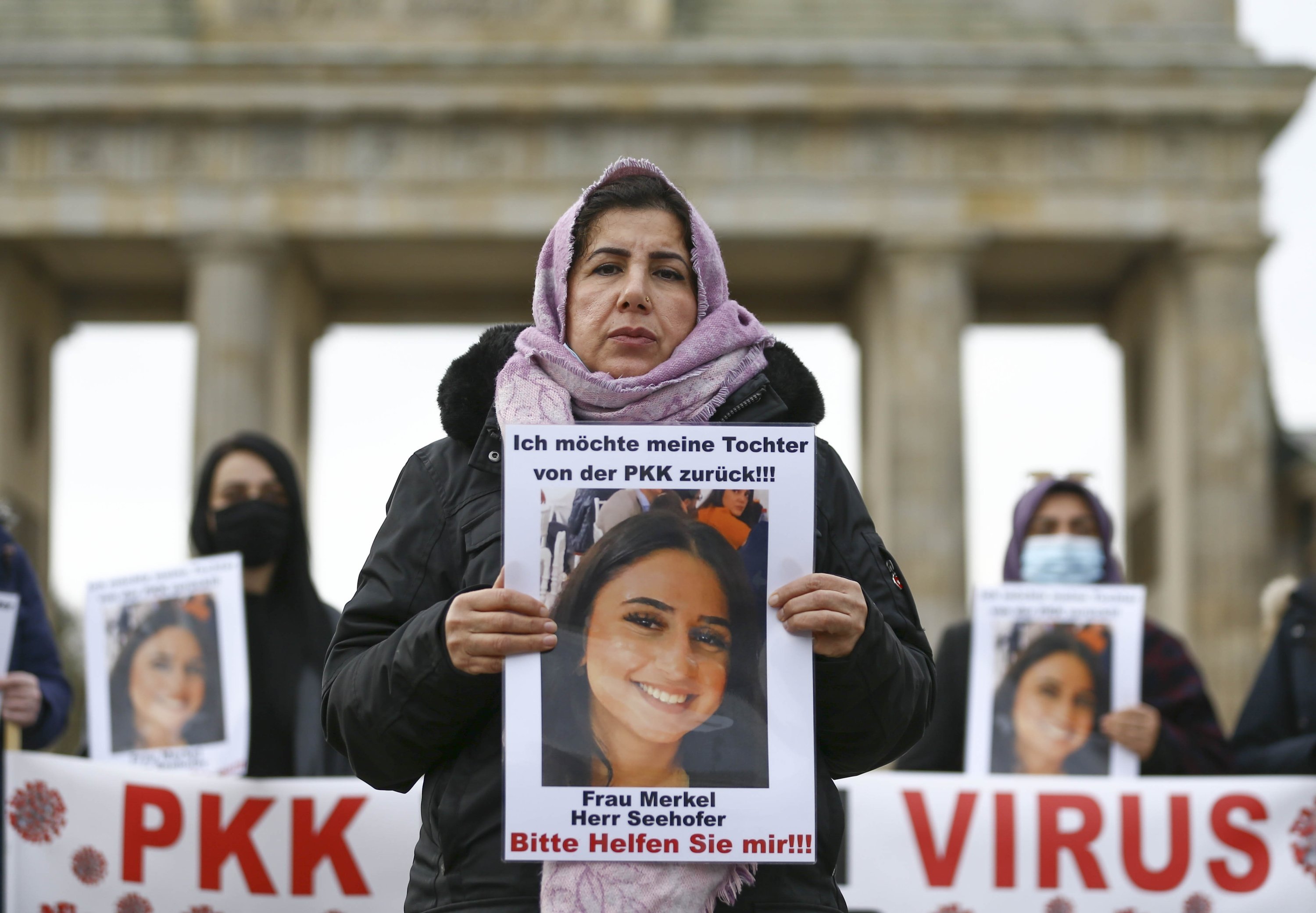 Mother Maide Töremiş holds a photo of her daughter abducted by PKK terrorists, during a protest in Berlin, Germany, Nov. 17, 2020. (AA Photo)
