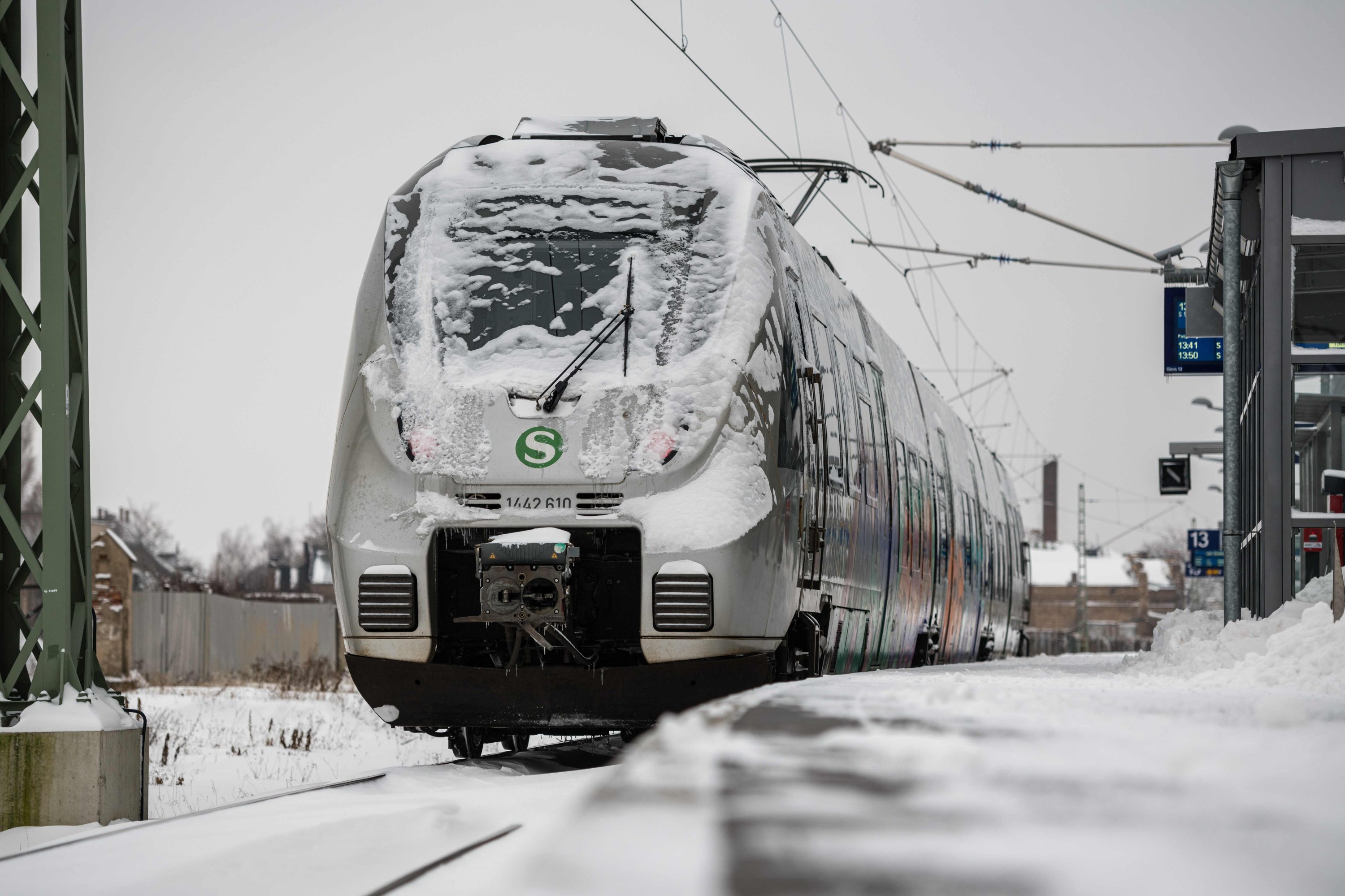 A snow-covered regional train stands on a platform at the central train station in Halle/Saale, eastern Germany, on January 07, 2021. (AFP Photo)