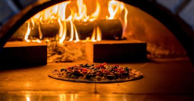 A wood-fired oven may feel like the secret to a crispy crust, but the key is not to use a rolling pin. (Shutterstock Photo)