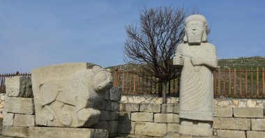The statue of the Hittite king Tarhunza near a lion statue at the entrance of the Arslantepe Archaeological Site, Malatya, eastern Turkey, Feb. 5, 2021. (AA PHOTO)